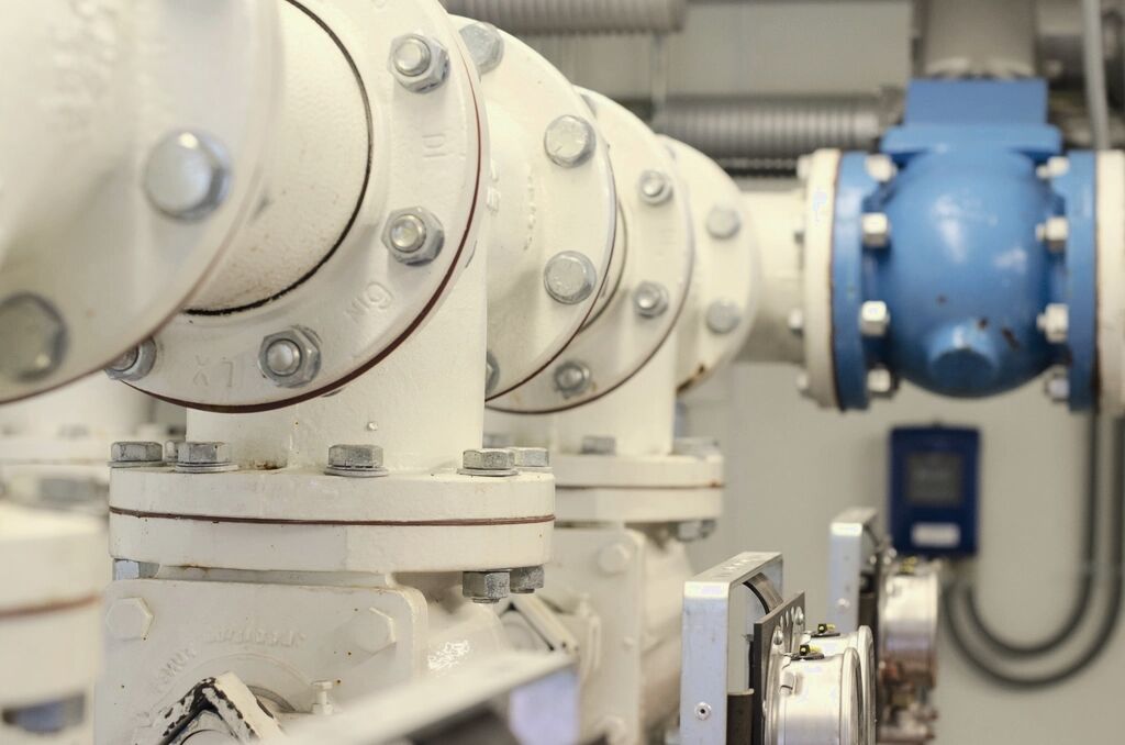 Industrial metal pipework and valve assembly in a plant environment (illustrative photography, not a Kestrel facility)